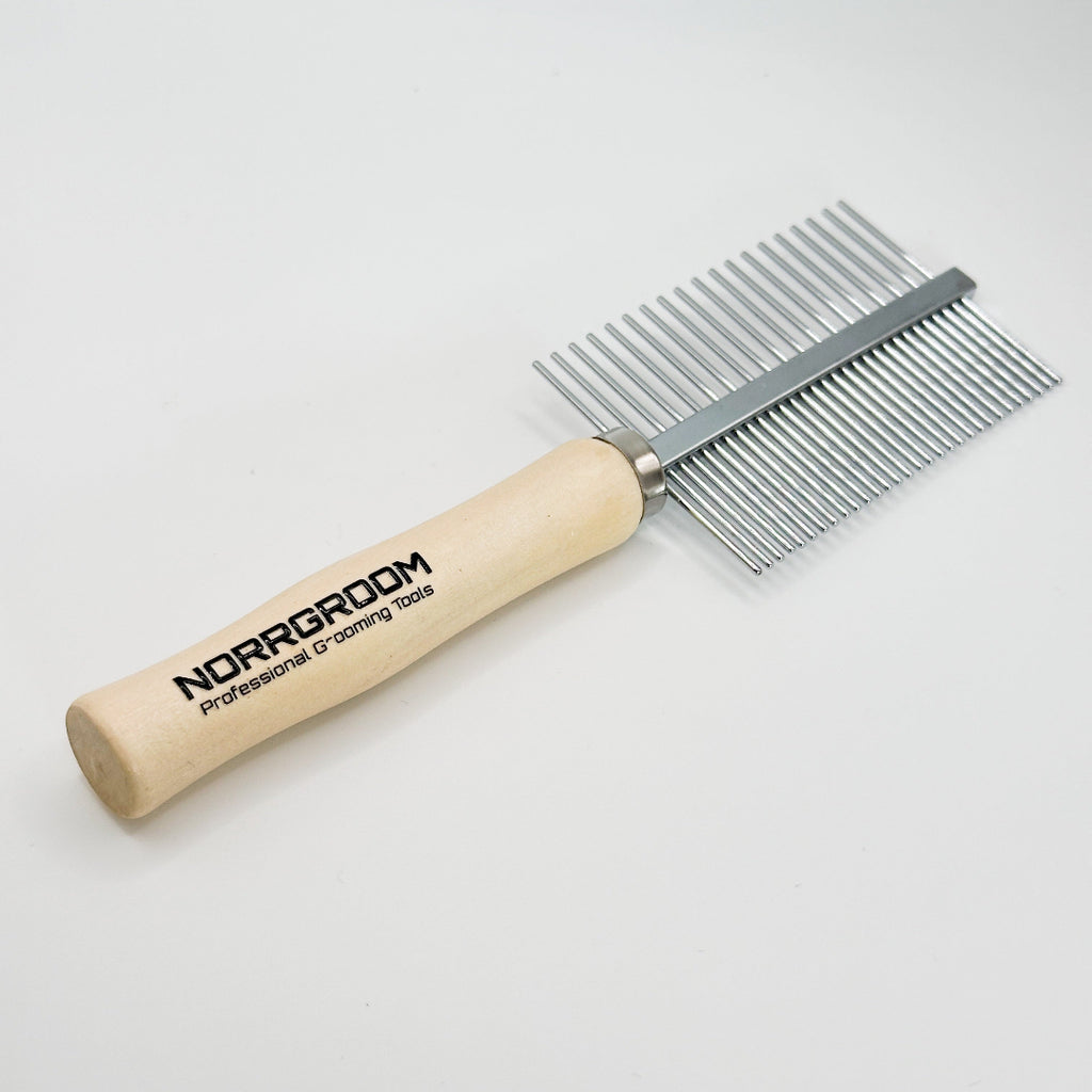 Close-up of fine and coarse stainless-steel teeth on NorrGroom wooden handle dog comb for grooming