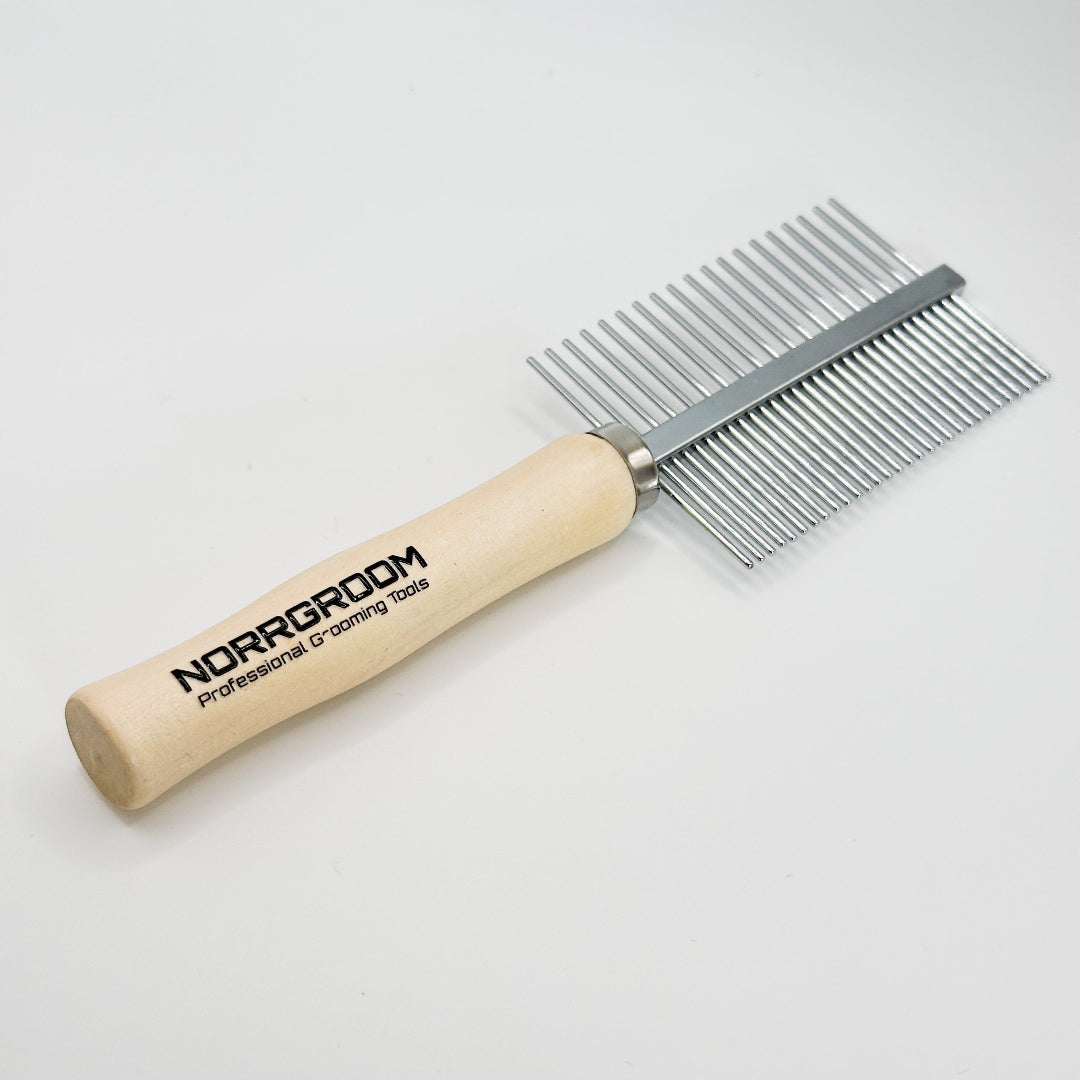 Close-up of fine and coarse stainless-steel teeth on NorrGroom wooden handle dog comb for grooming