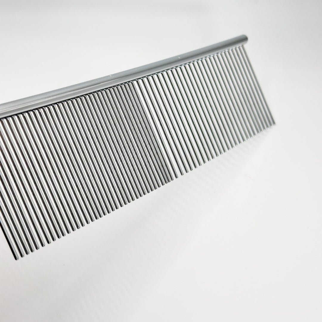 Close-up of NorrGroom 7.5 inch grooming comb showing extra-long teeth for deep coat grooming

