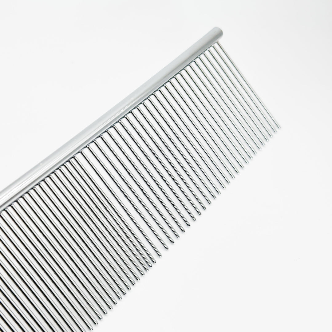 Professional groomer using NorrGroom 7.5 inch dual-sided dog comb on thick-coated breed

