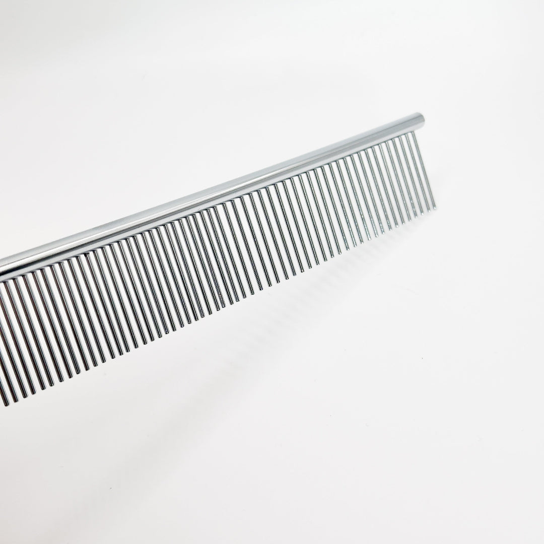 Groomer using NorrGroom 7.5 inch dog comb on small breed for facial and paw detailing

