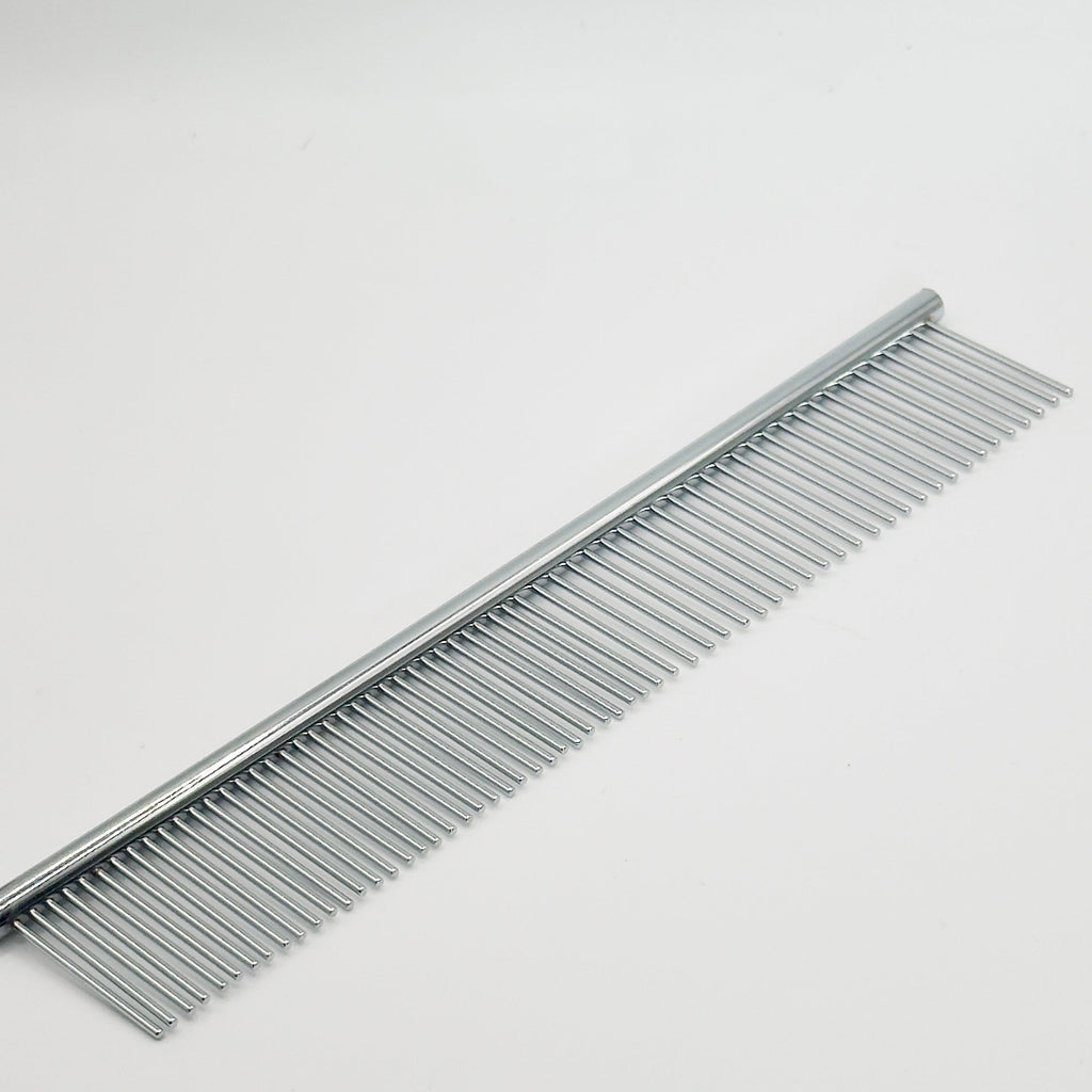 Close-up of NorrGroom dual-sided comb showing fine and coarse teeth for small breed grooming


